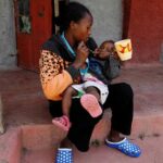 Education-_-Josephine-Wanjiru-feeds-her-child