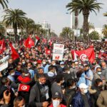 Tunisia's main party holds huge rally as government row grows