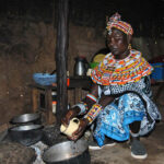 Jane Nolmongen washes a cup in her hut in Umoja village