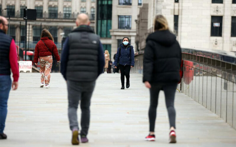 People walk across London Bridge