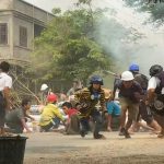 Myanmar protesters take cover during clashes with security forces