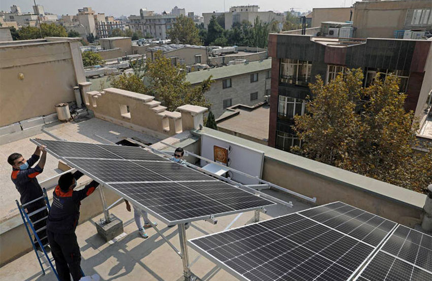 Technicians install solar panels on a residential rooftop