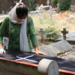 India-Person-standing-next-to-coffin