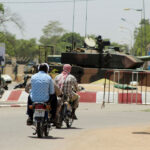 People-drive-past-Chad-army-tank