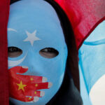 An-ethnic-Uighur-demonstrator-wears-a-mask