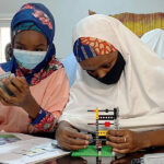 Female-students-assemble-Legos