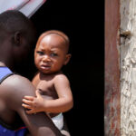 Moussa-Nigerian-migrant-carries-his-baby-boy