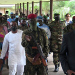Envoys from the Economic Community of West African States (ECOWAS) for the Guinea crisis are escorted out  after  their meeting with special forces commander Mamady Doumbouya, who ousted President Alpha Conde  in Conakry