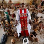 Reverend-Father-Paul-Obayi-amidst-several-artefacts