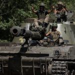 Ukrainian-servicemen-ride-a-self-propelled-howitzers