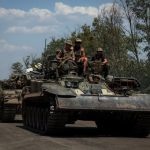 Ukrainian-servicemen-ride-on-a-military-vehicle