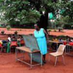 teacher-conducts-a-lesson-under-a-tree-in-Limpopo-Province