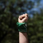 woman-raises-fist_abortion-rights-supporter