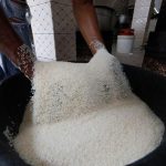 Amy-Gueye-checks-the-quality-of-rice
