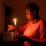 Maria-Modiba-cooks-by-a-candlelight