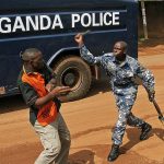 Uganda_policeman-beats-up-journalist