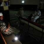 SA-power-outage_Muslim-man-sits-in-a-mosque