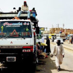 People-gather-to-ride-a-truck-to-flee_Khartoum