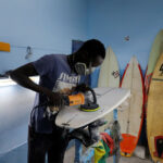 Pape-Diouf-repairs-surfboard