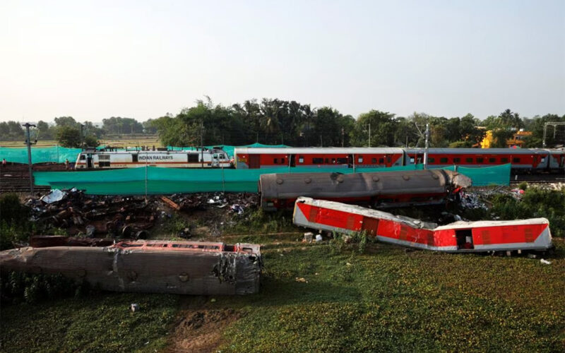 India investigates rail disaster as trains crawl through crash site