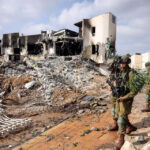 Israeli-soldiers-patrol_destroyed_-police-station