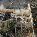 Palestinians-inspect-damages-of-a-house