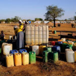 In Burkina Faso's blockaded towns, war crimes and mutual aid Woman_gather-water_displacement-camp_Kaya