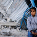Palestinian-child_demolished-house_Israeli-strike