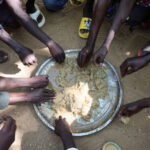 Refugees-eat-food-in-the-Adre-Sudanese-refugee-camp
