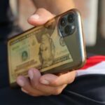 man-holds-a-mobile-phone