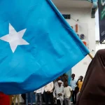 Somali woman carries their flag