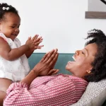 baby and mother playing