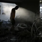 Palestinian man_Damaged house_Israeli strike in Rafah
