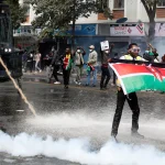 Police fire on demonstrators trying to storm Kenya parliament, several dead Kenya_demonstrator holds flag