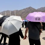 Muslim pilgrims hold hands