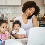 Mother with children working on laptop