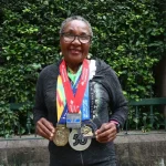 Joyce_Nduku_showing_some_of_her_medals_from_years_of_marathons