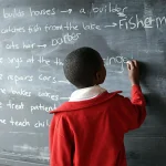 Child writing on blackboard_2