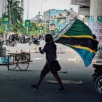 Amnesty International pressures African Union as Tanzania buries its dead Tanzania_protester_flag