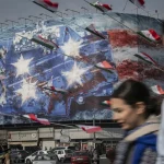Iranian youths_billboard_USS Abraham Lincoln