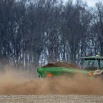farmer fertilising crops