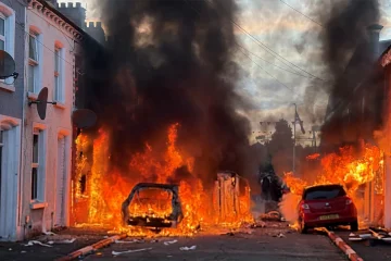 A KNIFE IN THE NECK OF BRITAIN: How one attack in Belfast ignited the UK’s most explosive immigration crisis in years